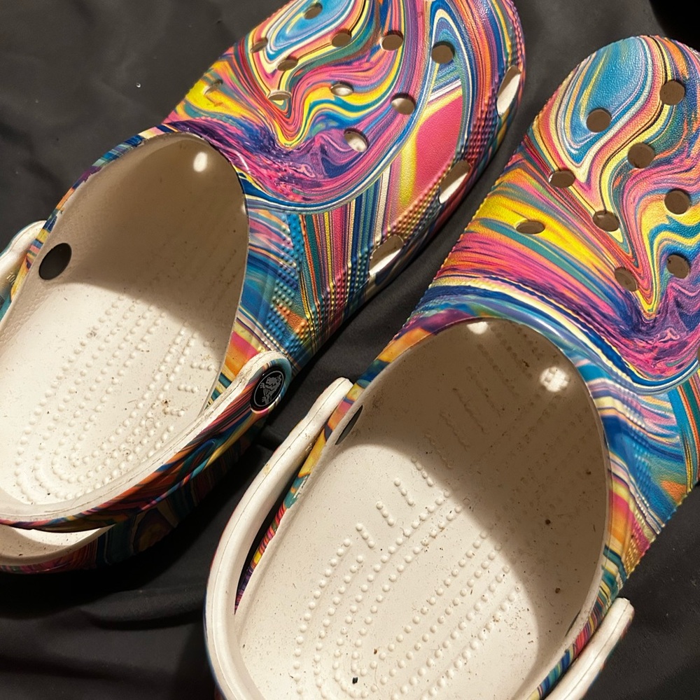 Multi colored crocs.